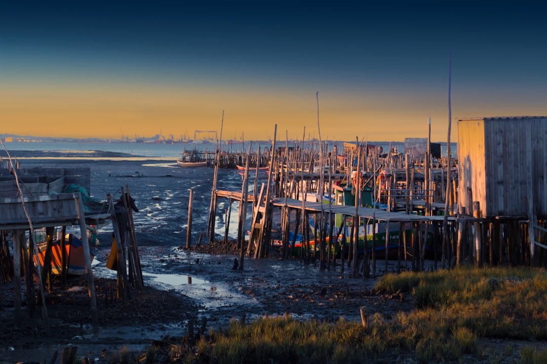 Coastal Chilean fishing village with wooden boats and fishermen at dawn