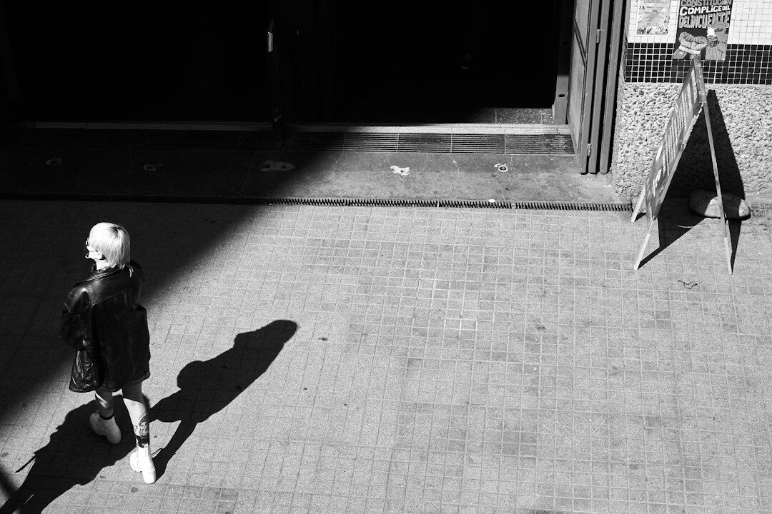 Portrait of a Chilean female documentary photographer holding a camera on a Santiago street