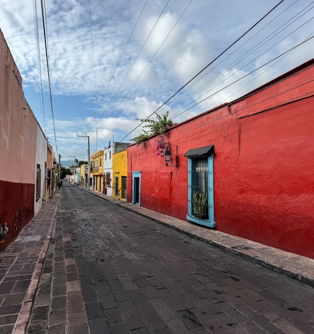 Narrow cobblestone street in Barrio Bellavista Santiago with colorful house facades