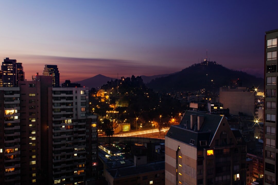 View of Santiago rooftops and the Andes from an apartment window at dusk